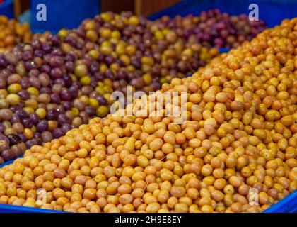 Olives in the market on the stall in istanbul at the farmers, fresh yellow olives Stock Photo