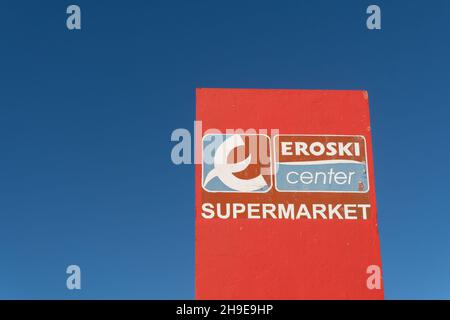 Campos, Spain; december 05 2021: Sign with the logo of the Eroski supermarket chain on a sunny morning Stock Photo