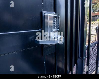 View of a secure pin lock keypad on a door in a big city's downtown area Stock Photo