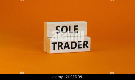 Time to sole trader symbol. Concept words Sole trader on wooden blocks on a beautiful orange background. Business and sole trader concept. Copy space. Stock Photo