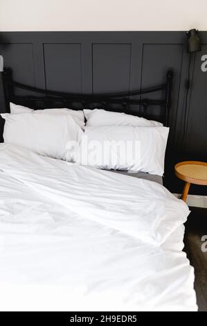 Soft pillows and duvet on comfortable bed Stock Photo