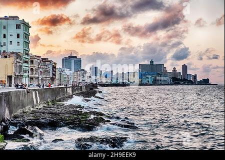 A dramatic sky settles in over the historic Malecon promenade on the waterfront of the Vedado District of Havana in Cuba. Stock Photo