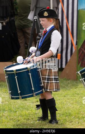 A young drummer in a Highland pipe band with her tenor drum in a Scottish festival in Utah. Stock Photo