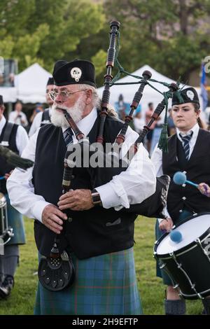 A bagpiper in full regalia performs at a Scottish festival in Moab, Utah. Stock Photo