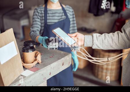 Customer pay with cellphone on pos terminal Stock Photo