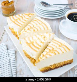 Cake with salty caramel and nuts on a chocolate sponge cake. Stock Photo