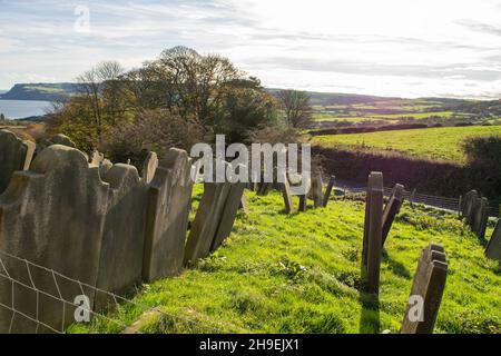 Old gravestones on a green slope in Yorkshire England Stock Photo