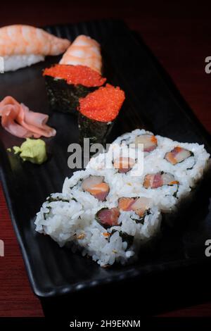 Japanese restaurant triple roll with tokiko and shrimp tail sushi Stock Photo