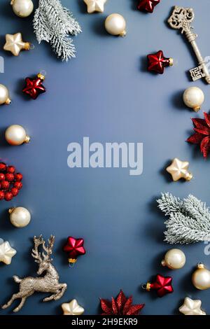Merry Christmas and Happy New Year vertical banner design. Frame made of fir branches, gold balls, stars, reindeer, key on dark blue background. Flat Stock Photo