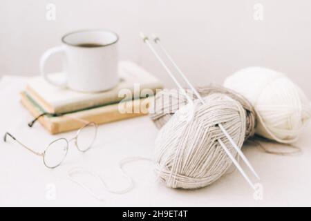 Threads for knitting, from natural environmentally friendly wool, close-up on a light background. Hobby home needlework Stock Photo