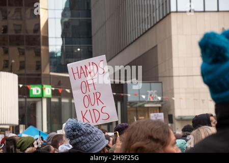Vancouver, Canada - November 20,2021: View of sign Hands Off Our Kids during The rally against the BC Vaccine Card in front of Vancouver Art Gallery Stock Photo