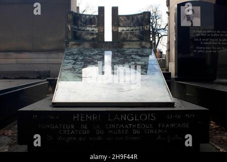 The grave of Henri Langlois - French film archivist and cinephile, and founder of the Cinemateque Francaise - decorated with film stills Montparnasse Stock Photo