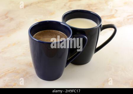 Hot chocolate and hot white chocolate drinks in blue mugs Stock Photo