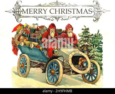 Victorian Christmas - Vintage car ladened with presents is being driven by two Santa Claus - Here comes Santa Claus Stock Photo