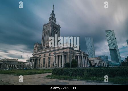 Palace of art and culture in Warsaw, Poland on a cloudy and rainy afternoon. Clouds are seen rushing past the sky. Beautiful portrait of polish histor Stock Photo