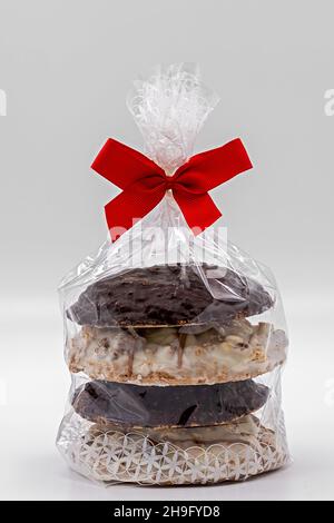 Homemade gingerbread packed in cellophane bag with red bow isolated on white background Stock Photo