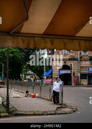 MUMBAI, INDIA - October 2, 2021: Unidentified man talking on mobile phone on the streets of Mumbai Stock Photo