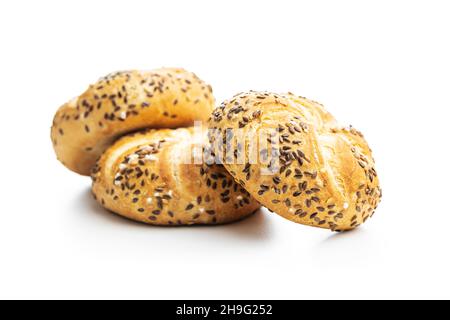 Four baked french buns with seeds isolated on white background. Stock Photo