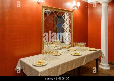 The buffet at the reception. Glasses of wine and champagne. Assortment of canapes on table. Banquet service. catering food, snacks with cheese and tom Stock Photo