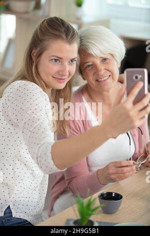 Young blogger shooting selfie with mom at home Stock Photo - Alamy