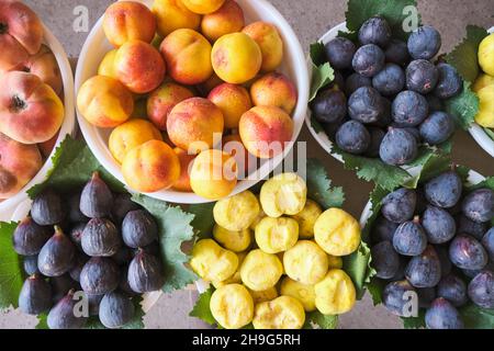 Bowls of peaches, nectarines, plums for sale. At Mirabad Bazaar, Mirobod Bozori in Tashkent, Uzbekistan. Stock Photo