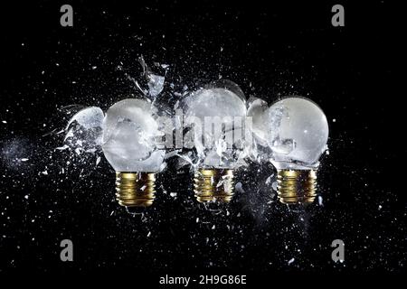 explosion of 3 light bulbs on the white background. high speed photography. Stock Photo