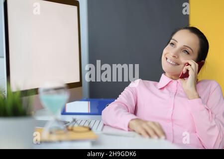 Happy office worker having break and talk on mobile phone during lunch Stock Photo
