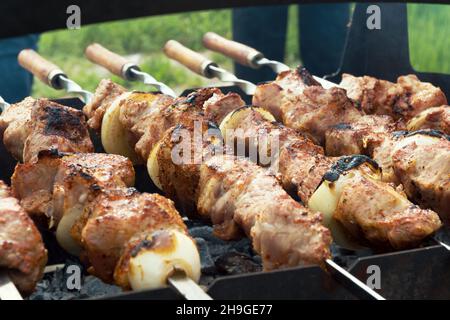 Marinated shashlik preparing on a barbecue grill over charcoal. Selective focus. Shashlyk (skewered meat) was originally made of lamb. Roast Beef Keba Stock Photo
