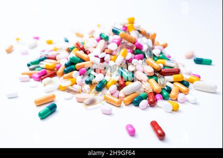Pile of drugs with a variety of colorful tablets, pills, capsules and dragees on white background Stock Photo