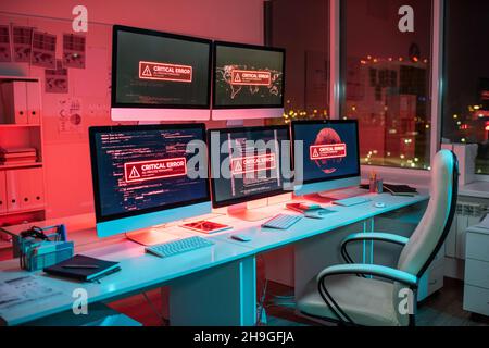 Empty openspace office with several computer screens announcing critical error during decoding process Stock Photo
