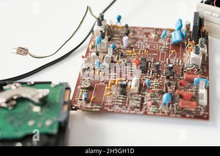 Part of circuit board with many tiny details, electronic schemes and cords on white background Stock Photo