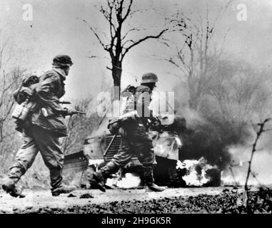 POTEAU, BELGIUM - 18 December 1944 - This image captured from the Nazis shows the Nazi Panzergrenadier-SS Kampfgruppe Hansen soldiers in action during Stock Photo