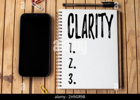 Conceptual caption Clarity. Business concept Being coherent intelligible Understandable Clear ideas Precision Empty Open Journal Beside Mobile With Stock Photo