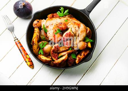 Grilled chicken legs with baked potatoes and figs.Meat roasted with figs. Stock Photo