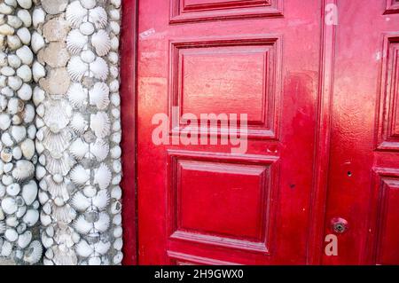 Shells wall and red door Stock Photo