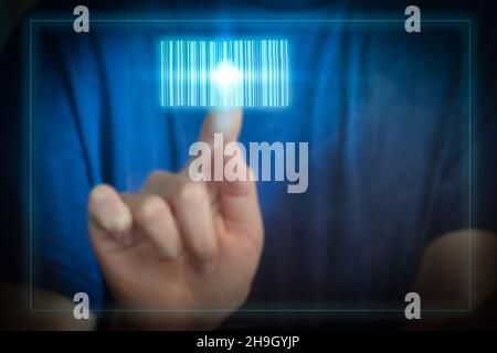 The businesswoman touches the barcode on the virtual tap. Scanning a hologram barcode on a tablet in your hand, warehouse and logistics. Modern manage Stock Photo