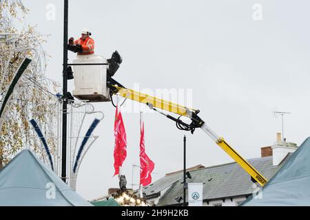 Hereford, Herefordshire, UK - Tuesday 7th December 2021 - UK Weather - Local authority workers strive to complete the installation of Christmas lights despite the strong winds and heavy rain in Hereford city centre as Storm Barra aprroaches from the West - Photo Steven May / Alamy Live News Stock Photo