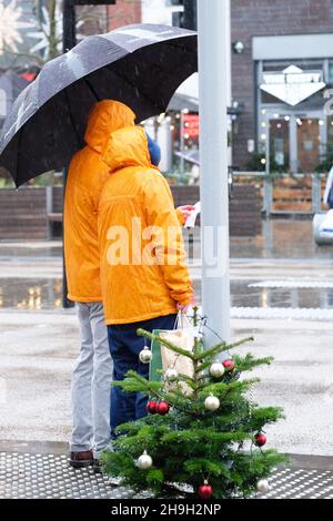 Hereford, Herefordshire, UK - Tuesday 7th December 2021 - UK Weather - Xmas shoppers brave the strong winds and heavy rain in Hereford city centre as Storm Barra aprroaches from the West - Photo Steven May / Alamy Live News Stock Photo