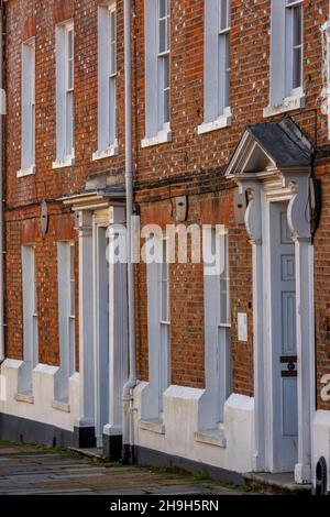 terraced period townhouses in newport on the isle of wight, period houses, period homes, georgian frontages, georgian town houses, front doors, street Stock Photo