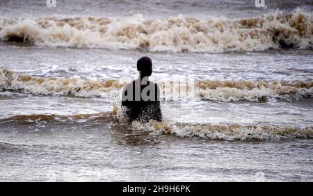 Waves close in towards one of the Anthony Gormley statues called Another Place at Crosby Beach Merseyside as Storm Barra hit the UK and Ireland with disruptive winds, heavy rain and snow on Tuesday. Picture date: Tuesday December 7, 2021. Stock Photo