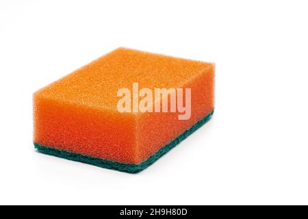 Foam sponge of orange color with abrasive material used daily by all housewives to clean house. White background. Close-up view, horizontal Stock Photo