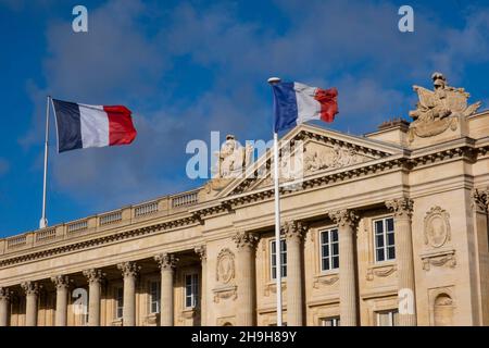 French flags in front of building in Paris, France Stock Photo