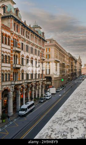 Elevated street view of Via XX Settembre with ancient palaces in the centre of Genoa at sunset, Liguria, Italy Stock Photo