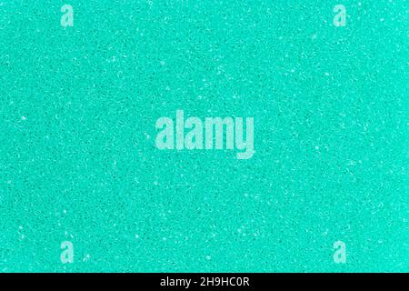 Turquoise color foam sponge porous texture background. Extreme close-up view of detail abstract synthetic material. Horizontal composition. Stock Photo