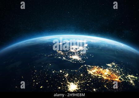 Amazing blue planet earth with night city lights on the starry sky in space. Great Britain, London view from space. Electricity and power supply conce Stock Photo