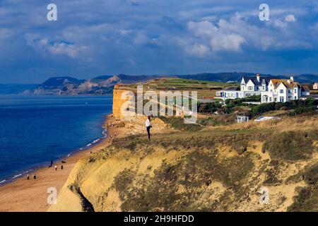 Looking west along the Jurassic Coast towards Golden Cap from the top of the unstable cliffs at Burton Bradstock in Dorset, England, UK Stock Photo