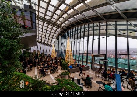 London, England, United Kingdom - December 7, 2021: Wide view of the Sky Garden terrace decorated with Christmas trees and lights in the 20 Fenchurch S Stock Photo