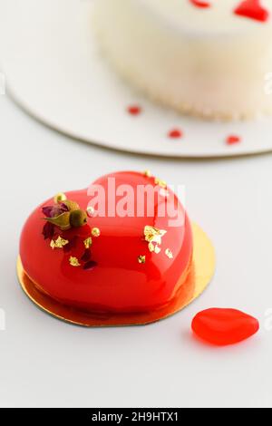 A cake in heart shape. Cupcakes in the shape of a heart on a white background. Valentine's Day. Vertical photo Stock Photo