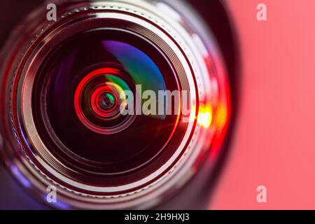 The camera lens and the red backlighting. Red  camera Lens close Up. horizontal photo Stock Photo