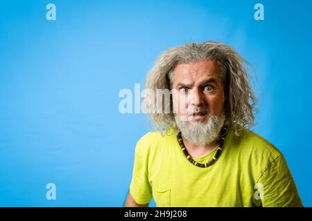 hipster man looking at the camera with surprised and astonished expression, copy space Stock Photo